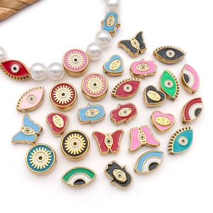 Macro shot of colorful enamel evil eye beads and Hamsa hand charms for DIY jewelry making