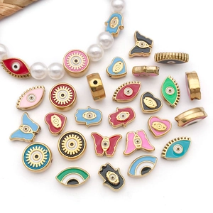 Golden evil eye enamel spacer beads including Hamsa hand and heart shapes for DIY jewelry