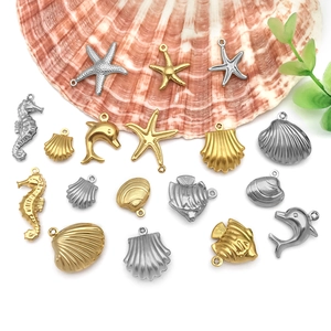 Detailed view of hollow gold and silver sea animal charms for DIY jewelry making