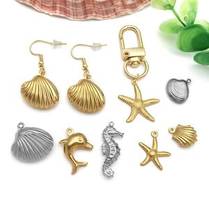Golden and silver marine life charms including seahorse, dolphin, and starfish pendants