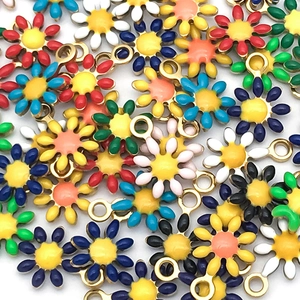 Detailed view of colorful enamel daisy charms with stainless steel loops for DIY jewelry