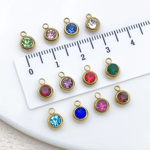 Colorful stainless steel birthstone charms set with scale ruler on white background