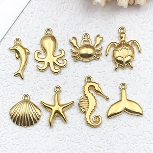 Golden stainless steel ocean pendants set featuring sea turtle starfish and seashell