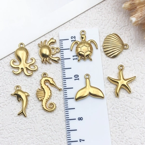 Golden stainless steel ocean pendants featuring starfish and seahorse with measurement scale