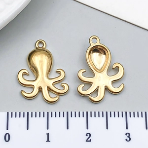 Detailed view of octopus charms in gold stainless steel with size scale measurement