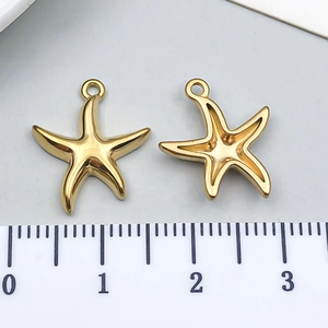 Macro detail of golden starfish pendants showing polished front and hollow back designs