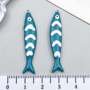 Detail of 4cm peacock blue enamel fish charms with golden rings and measuring ruler