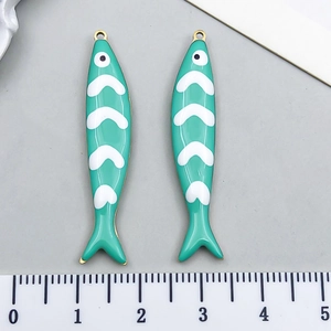 Detail of 4.5cm stainless steel fish charms with green enamel and gold finish for DIY