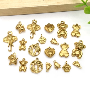 Detailed close-up of gold stainless steel animal charms for DIY jewelry making