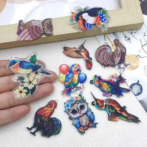 Detailed view of colorful acrylic bird charms for DIY jewelry and crafts making