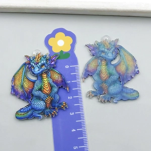 Detail showing acrylic dragon pendants in rainbow and icy blue with measurement scale