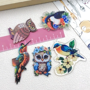 Acrylic bird charms for DIY jewelry making featuring owl and parrot designs with ruler