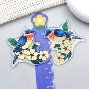 Detail view of acrylic bird pendant with floral print and scale measurement