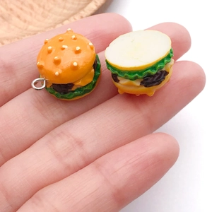 Close-up of a miniature resin burger charm with lettuce and meat layers for DIY jewelry