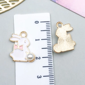 Detailed front and back view of rabbit charm with pearl tail and gold texture