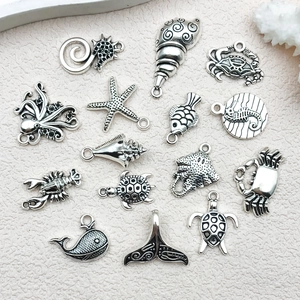 Macro detail of 15 antique silver ocean animal charms for DIY necklace and bracelet crafting