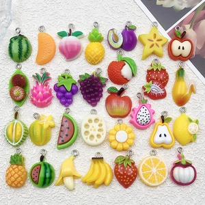 Macro detail of various colorful 3D resin fruit charms for DIY jewelry making and crafts