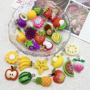 Macro shot of colorful resin fruit pendants including strawberry and banana for DIY jewelry