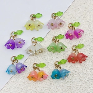 Macro detail of acrylic lily of the valley pendants for DIY jewelry making in multiple colors
