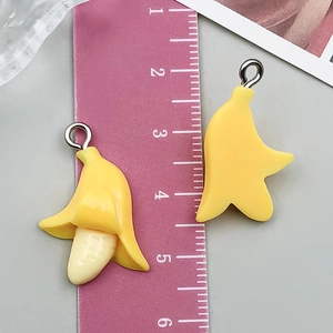 Macro detail of 3D resin banana charms showing realistic textures and silver jump rings