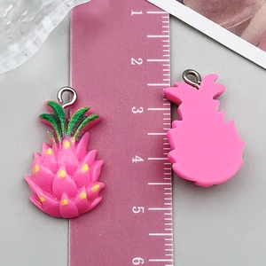 Detailed macro view of 3.5cm pink resin pineapple pendant charms with measurement ruler