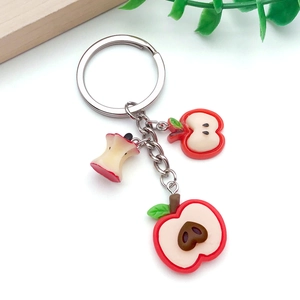 Detalle de dijes de manzana en resina 3D para joyas DIY con diseños de frutas cortadas