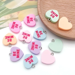 Colorful heart-shaped resin charms with Be Mine engraving and silver metal loops