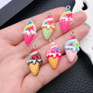 Detail view of colorful resin ice cream charms with metal hooks for DIY jewelry making