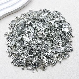 Macro view of silver alloy ocean charms featuring seahorse, starfish and dolphin details