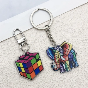 Bunte Acryl-Anhänger als Elefant und Würfel mit silbernen Schlüsselringen auf Weiß