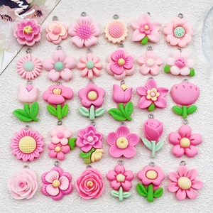 Flat lay of diverse resin flower charms including roses and daisies for DIY jewelry making