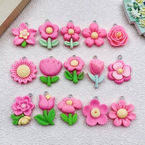 Detailed collection of fifteen pink resin flower pendants including tulip and sunflower