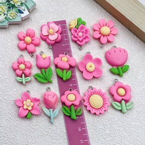 Flat lay of pink resin flower pendants with metal loops for DIY jewelry making