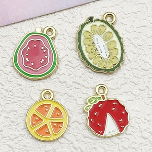 Macro detail of enamel fruit charms showing durian, guava and orange textures