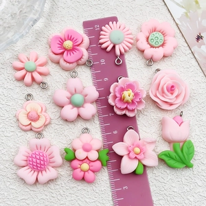 Pink resin flower charms featuring daisy and rose designs for DIY jewelry making