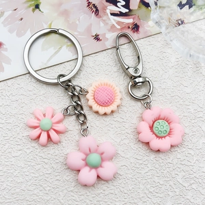Detailed view of pink resin sunflower charms with lobster clasp and chain for DIY jewelry