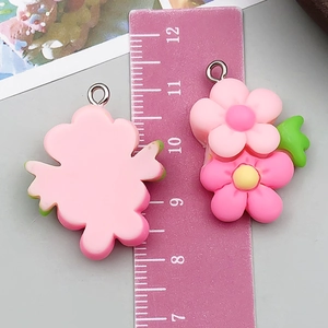Detailed view of pink resin flower pendant with size scale for DIY jewelry making
