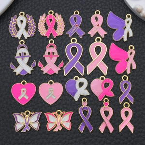 Macro display of pink enamel ribbon and heart charms for DIY jewelry making