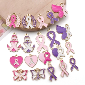 Detailed macro view of pink enamel ribbon alloy charms for DIY jewelry handmade crafts