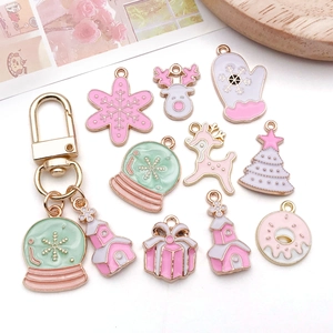 Pink Christmas charms set featuring snowflakes and gift boxes for DIY jewelry making