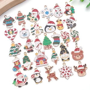 Detailed close-up of colorful enamel Christmas charms including Santa, Reindeer and trees