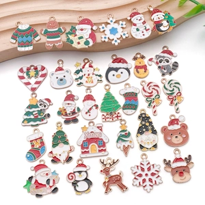 Flat lay of colorful Christmas alloy enamel pendants including Santa and trees
