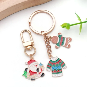 Detail of Christmas enamel pendants featuring Santa, Gingerbread Man and festive sweater