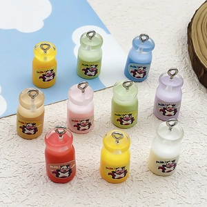 Macro detail of multi-colored resin milk bottle pendants with cartoon cow and metal loops