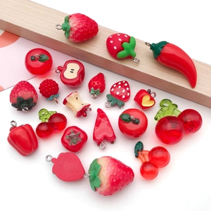Macro detail of various resin fruit charms like strawberry and apple for DIY jewelry