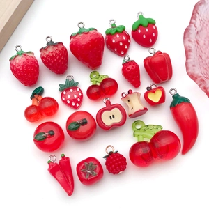 Detailed view of red resin fruit charms including strawberry and apple with metal hooks