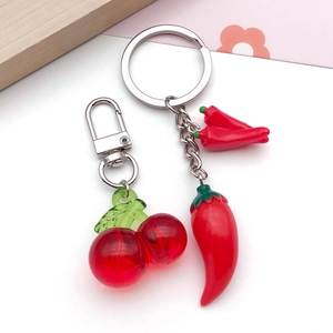 Detail shot of 3D resin fruit charms including red cherry and chili pepper keychains