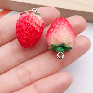 Macro shot of realistic resin strawberry charms with detailed textures and metal rings
