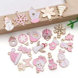 Macro shot of pink and white Christmas alloy enamel pendants with delicate rhinestone details