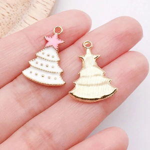 Detail showing front and back of white enamel Christmas tree pendant with pink star
